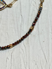 Gemstone evil eye in a chain