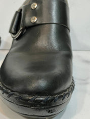 Black leather clogs