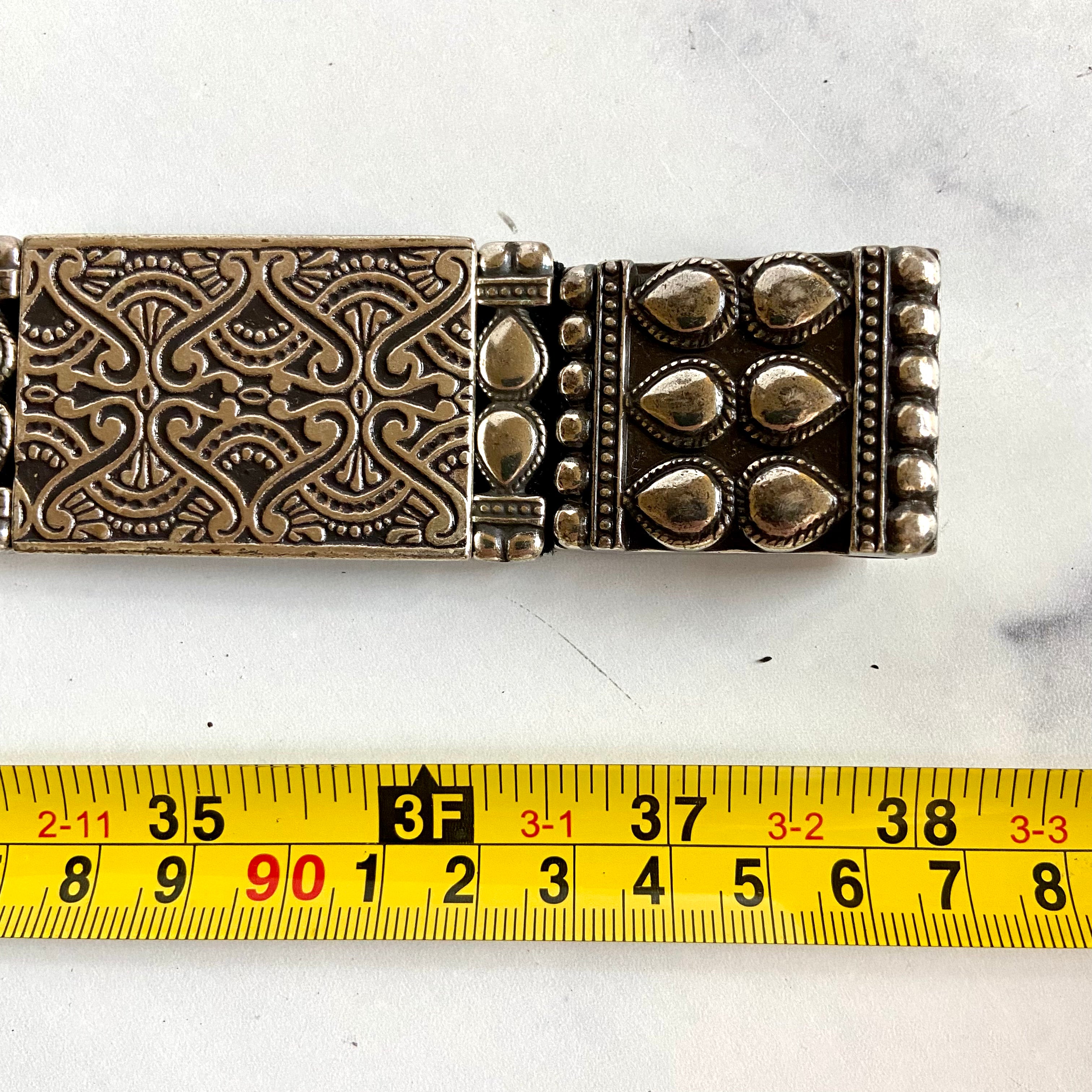 Silver toned hammered metal stretch belt
