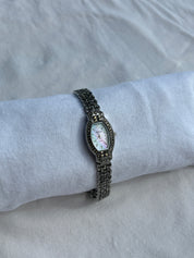 black crystal watch with cotton candy mother of pearl dial