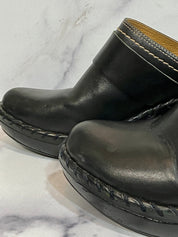 Black leather clogs