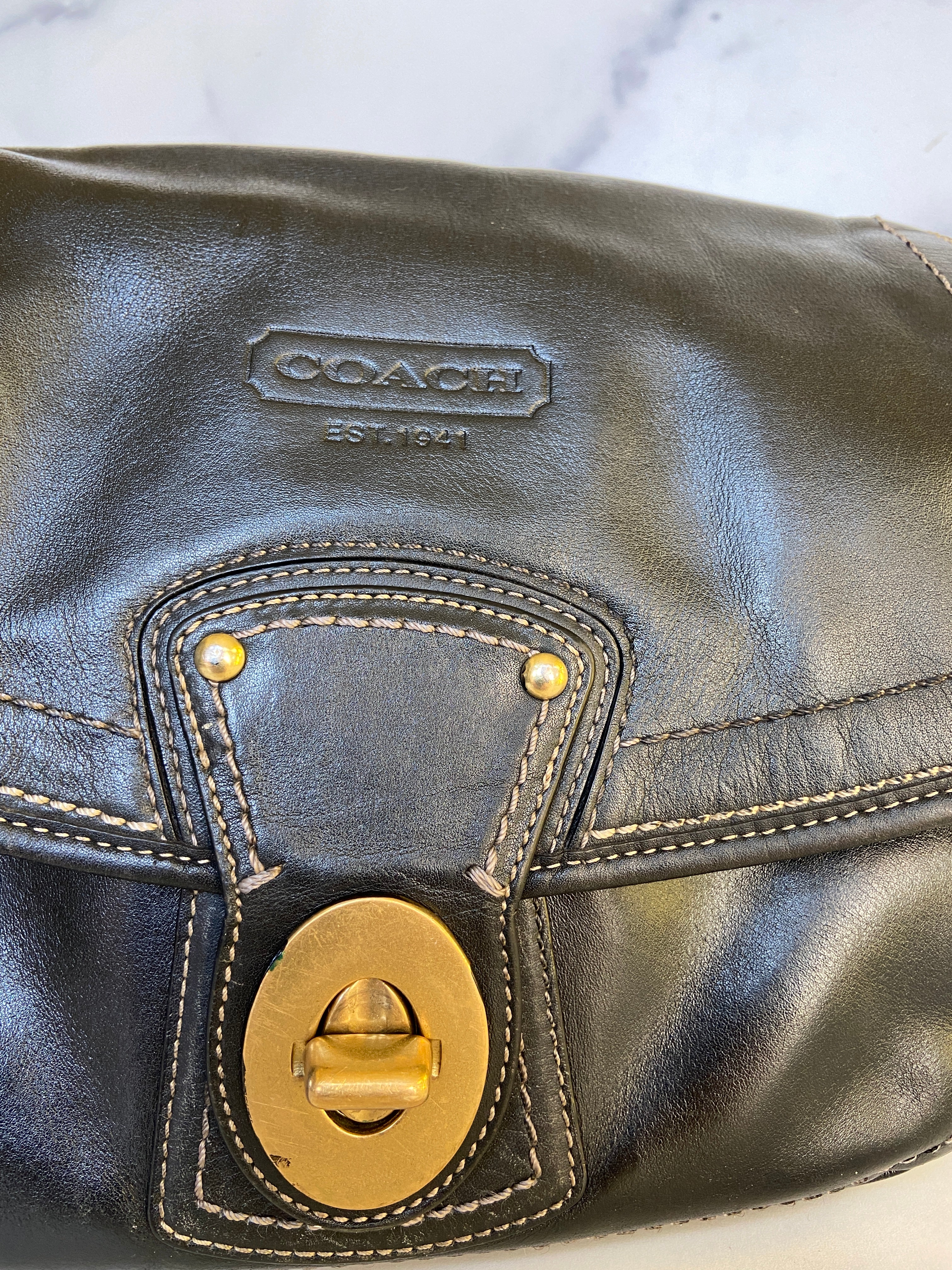 Reworked black leather coach
