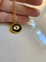 Black and gold evil eye