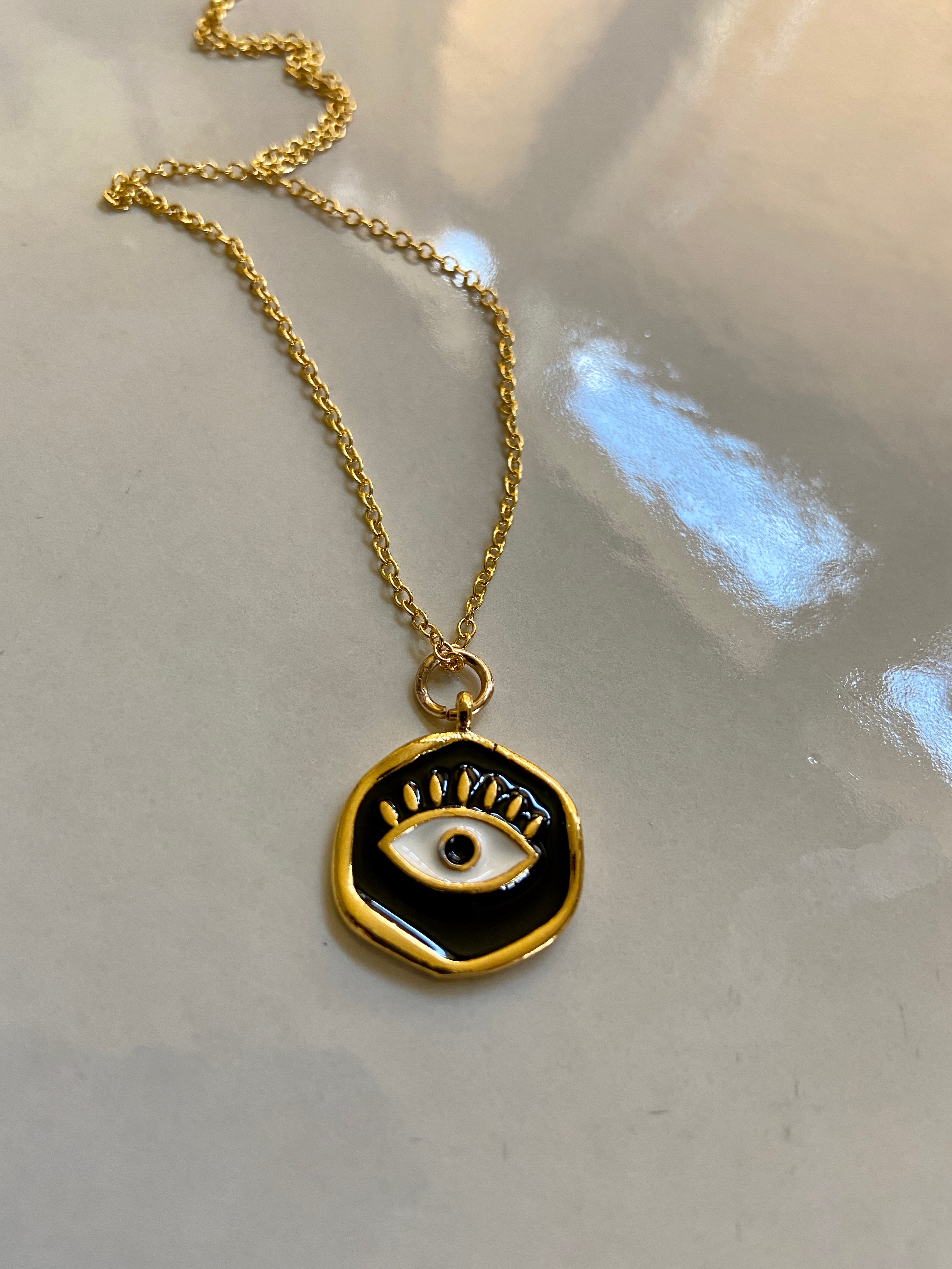 Black and gold evil eye